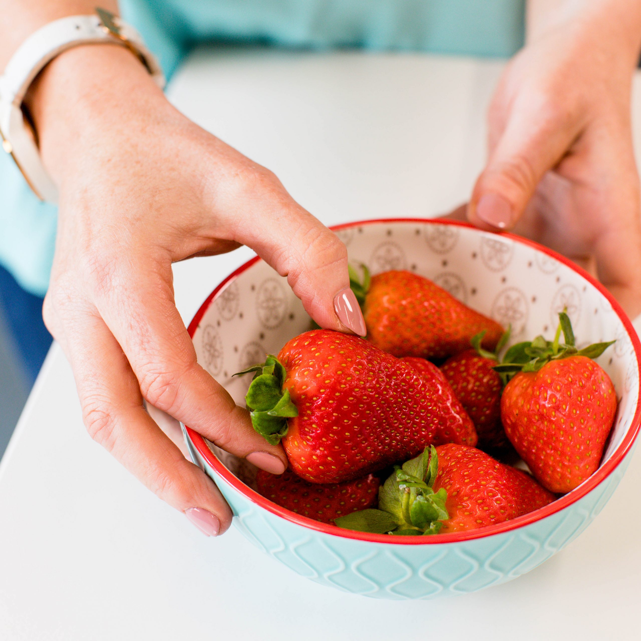 nutritionist hands with bowl of strawberries